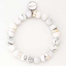 Load image into Gallery viewer, White howlite bracelet top view with silver spacer beads and round brand charm by MysticFlavia