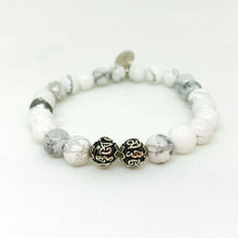 Load image into Gallery viewer, White howlite stone bracelet close-up showing 925 sterling silver beads, side angle view