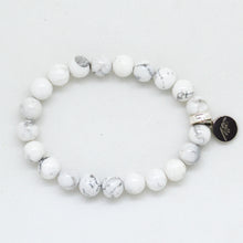 Load image into Gallery viewer, White howlite flat silver bead bracelet with MF charm, side angle view white background