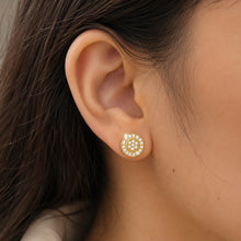 Load image into Gallery viewer, Gold plated moissanite stud earrings shown on a model ear

