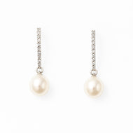 White pearl silver drop earrings on a white background