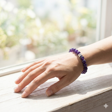 Load image into Gallery viewer, Woman wearing purple crystal bracelet near window in soft natural light indoors
