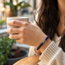 Load image into Gallery viewer, Woman wearing MysticFlavia amethyst bracelet while holding a coffee mug indoors
