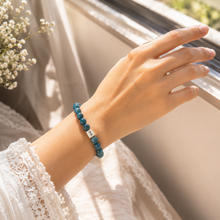 Load image into Gallery viewer, Woman wearing Blue Apatite Infinity Silver Bead Bracelet 8mm with natural gemstone beads and sterling silver infinity bead | MysticFlavia
