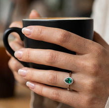 Load image into Gallery viewer, MysticFlavia emerald silver ring worn on hand with coffee cup

