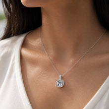 Load image into Gallery viewer, Woman wearing MysticFlavia moissanite pendant necklace, close-up on neck, 925 sterling silver halo design.
