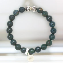 Load image into Gallery viewer, Bloodstone silver bead bracelet by MysticFlavia with engraved silver beads, on marble surface, close-up view

