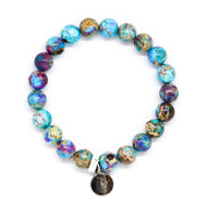 Blue Jasper Stone Flat Silver Bead Bracelet 8mm with natural blue jasper beads and a silver charm on a white background.