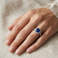 Load image into Gallery viewer, Blue gemstone silver ring worn on a woman's hand with diamond accents
