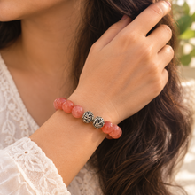 Load image into Gallery viewer, Woman wearing Cherry Quartz Stone Silver Bead Bracelet 12mm with polished gemstone beads and decorative silver accents
