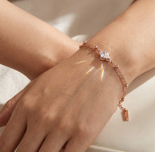 Load image into Gallery viewer, Chic Rose Gold Oval Zircon Studded Bracelet worn on a model’s wrist.
