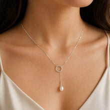 Load image into Gallery viewer, Round pearl drop lariat silver necklace worn on a model, elegant close-up
