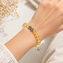 Load image into Gallery viewer, Golden gemstone bead bracelet worn on wrist with decorative 925 sterling silver beads and charm
