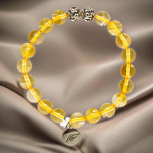 Load image into Gallery viewer, Citrine bracelet displayed on satin fabric with golden crystal beads and ornate silver bead accents
