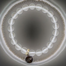 Load image into Gallery viewer, Clear quartz bracelet with 925 sterling silver MF charm, top-down view inside textured ceramic bowl
