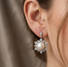 Load image into Gallery viewer, Natural pearl snowflake zircon silver earring worn on a model’s ear
