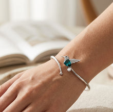 Load image into Gallery viewer, Blue Swarovski crystal hummingbird bracelet on wrist in 925 sterling silver
