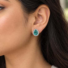 Load image into Gallery viewer, Emerald green gemstone 925 sterling silver stud earrings worn on a model
