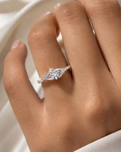 Load image into Gallery viewer, Moissanite silver ring worn on a model finger with detailed stone setting
