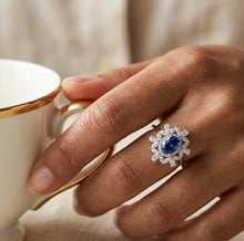 Load image into Gallery viewer, Flower blue topaz silver ring worn on a woman's hand

