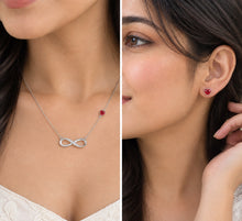 Load image into Gallery viewer, Woman wearing Mystic Flavia Infinity crystal silver necklace set with infinity pendant and red heart stud earrings
