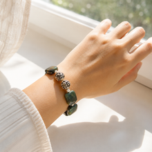 Load image into Gallery viewer, Female model wearing MysticFlavia Fancy Jasper Square Bead Bracelet 12MM in natural window light
