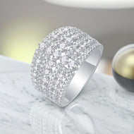 Moissanite ring with a wide pavé design in polished silver, showcasing brilliant round stones