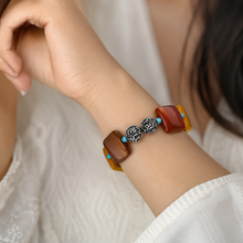 Load image into Gallery viewer, Mookaite Jasper Square Silver Bead Bracelet 12MM by Mystic Flavia worn on a woman's wrist in a soft lifestyle setting, showcasing natural mookaite jasper and silver beads.
