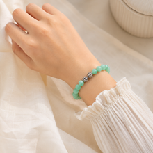 Load image into Gallery viewer, Person wearing MysticFlavia Jade bracelet with silver beads on wrist

