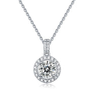 Moissanite halo pendant necklace in silver, round centre stone with pave border, front view on white background.