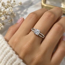 Load image into Gallery viewer, Moissanite ring worn on a hand, featuring a round center stone and delicate pavé split band
