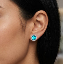 Load image into Gallery viewer, Woman wearing paved blue ocean crystal stud earring, close-up on ear.
