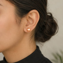 Load image into Gallery viewer, Pink natural pearl silver earrings worn on a model, showcasing the elegant stud design

