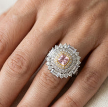 Load image into Gallery viewer, Pink gemstone paved silver ring worn on a woman's finger, showcasing the halo design
