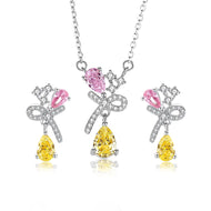 Pink and yellow gemstone silver necklace set with matching earrings on white background