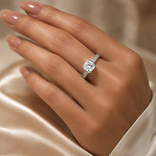 Load image into Gallery viewer, MysticFlavia moissanite solitaire ring worn on a hand with a sparkling stone-set silver band
