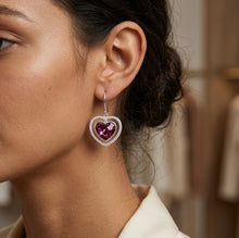 Load image into Gallery viewer, Woman wearing purple heart crystal drop earring, close-up on ear.
