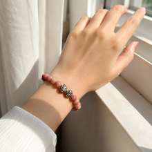 Load image into Gallery viewer, Female model wearing Rhodonite stone silver bead bracelet 8mm with natural light by a window
