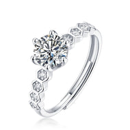 Round cut moissanite silver ring with hexagon accent stones close-up