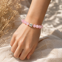 Load image into Gallery viewer, MysticFlavia rose quartz bracelet worn on hand in soft natural sunlight
