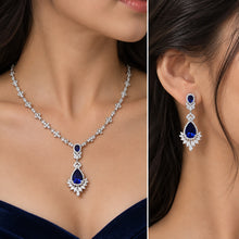 Load image into Gallery viewer, 925 sterling silver blue sapphire necklace and matching earrings worn by a model
