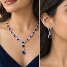 Load image into Gallery viewer, Blue gemstone silver necklace and drop earrings worn by a woman, showcasing the elegant jewelry design
