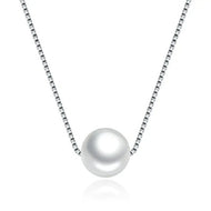 Single white pearl pendant silver necklace on a clean background
