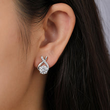 Load image into Gallery viewer, MysticFlavia crossover moissanite earrings in 925 sterling silver worn on a model’s ear
