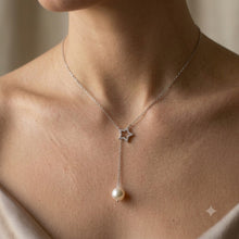 Load image into Gallery viewer, Woman wearing star pendant lariat pearl necklace in silver, close-up on neck and collarbone.

