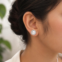 Load image into Gallery viewer, White pearl stud earrings with zircon halo, crafted in 925 sterling silver and worn by a model
