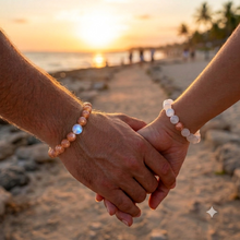 Load image into Gallery viewer, Couple wearing matching Sunstone and Moonstone 8MM gemstone bracelets while holding hands at the beach during sunset
