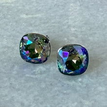 Load image into Gallery viewer, Pair of Swarovski crystal stud earrings, iridescent blue-green stones, close-up on grey background.
