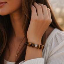 Load image into Gallery viewer, Woman wearing tiger eye double flat silver bracelet 12mm, outdoor lifestyle close-up shot
