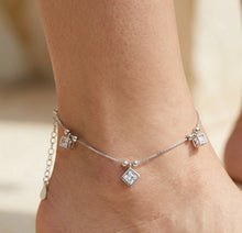 Load image into Gallery viewer, Three Square Box White Zircon Silver Anklet styled on a model’s ankle in a close-up view
